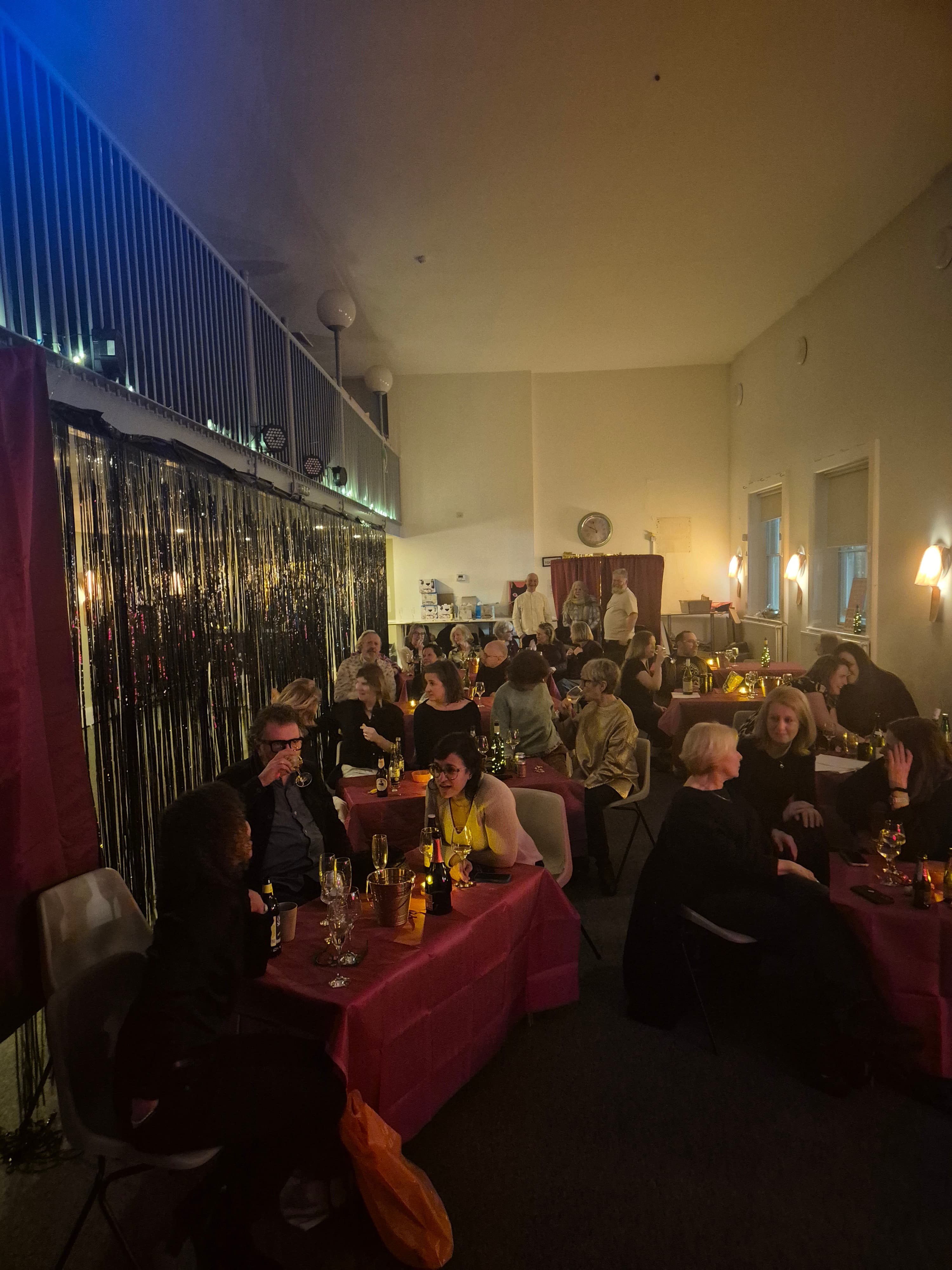 Audience members talking and laughing during the performance