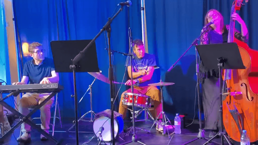 The house band performing with a singer